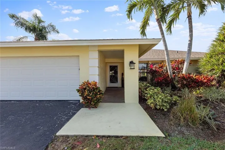 Doorway to property with a garage