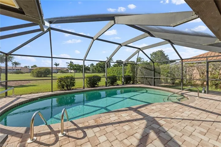 View of pool with a lanai and a patio area