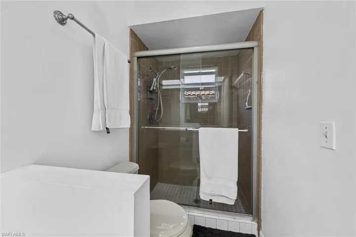 Primary Bathroom with an enclosed shower and toilet