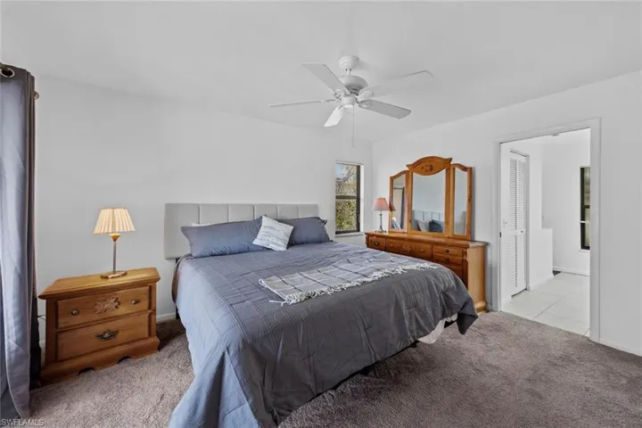 Primary carpeted bedroom featuring ceiling fan and a closet