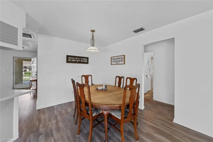 Dining room with dark wood-type flooring