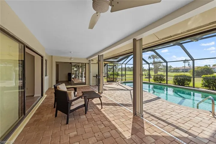 View of pool featuring ceiling fan, a lanai, and a patio