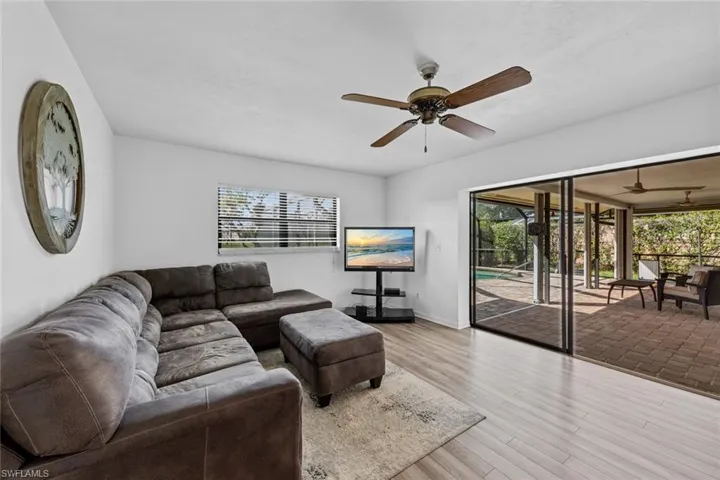 Living room featuring ceiling fan, light hardwood / wood-style flooring, and plenty of natural light