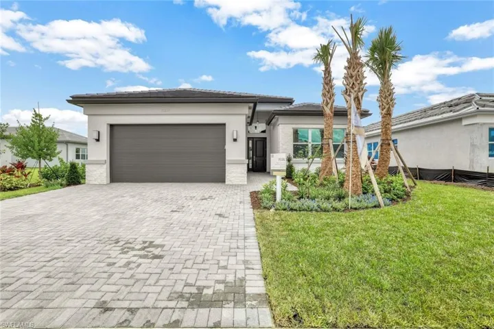 Home featuring a front yard and a garage