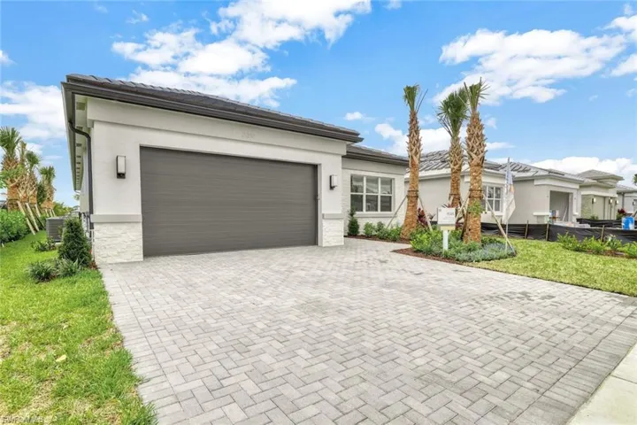 View of front of house with a front yard, a garage, and central AC unit