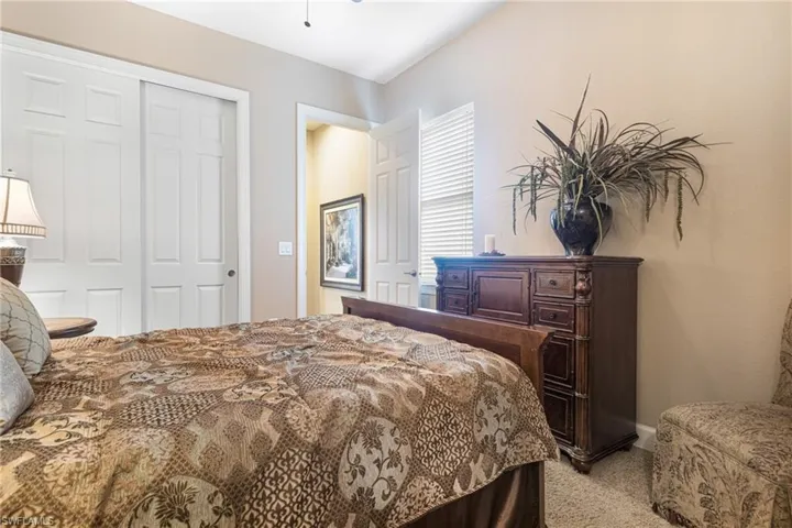Carpeted bedroom with a closet