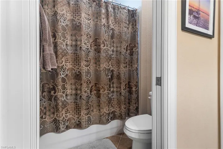 Full bathroom featuring tile patterned floors and toilet