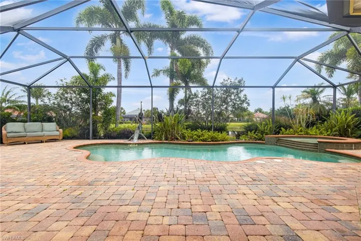 View of pool with a patio area, a lanai, and a pool with connected hot tub