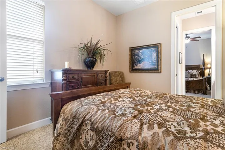 Bedroom with carpet flooring, visible vents, and baseboards