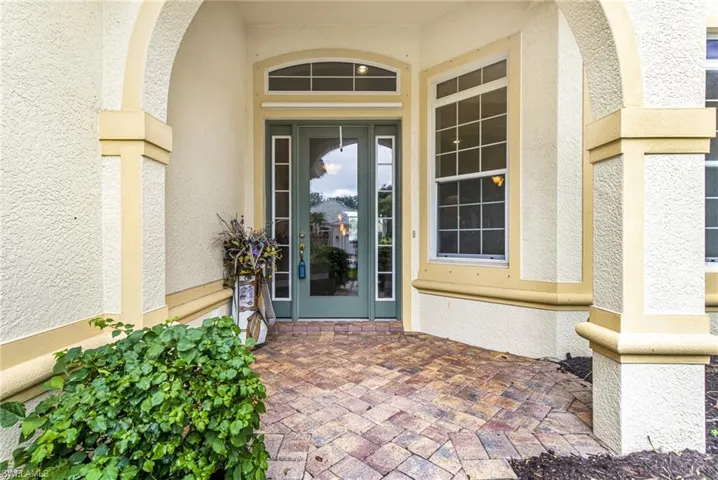 Doorway to property with stucco siding