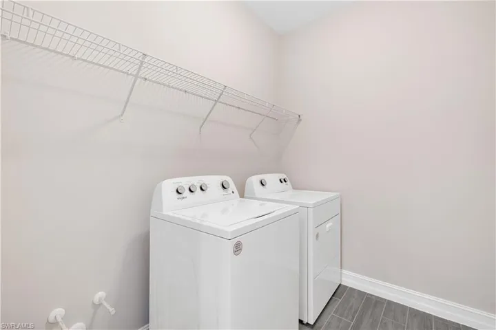 Washroom featuring washing machine and dryer