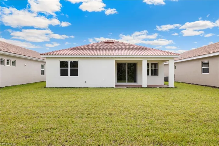 Back of house featuring a yard