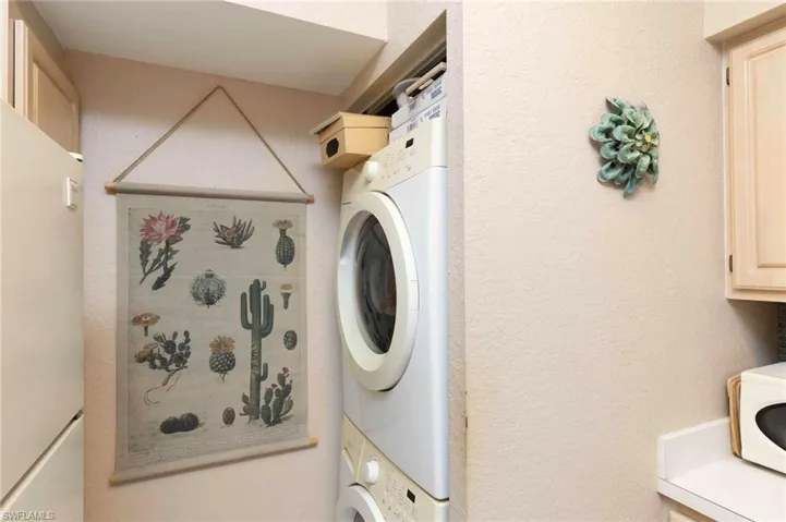 Washroom with stacked washer / drying machine