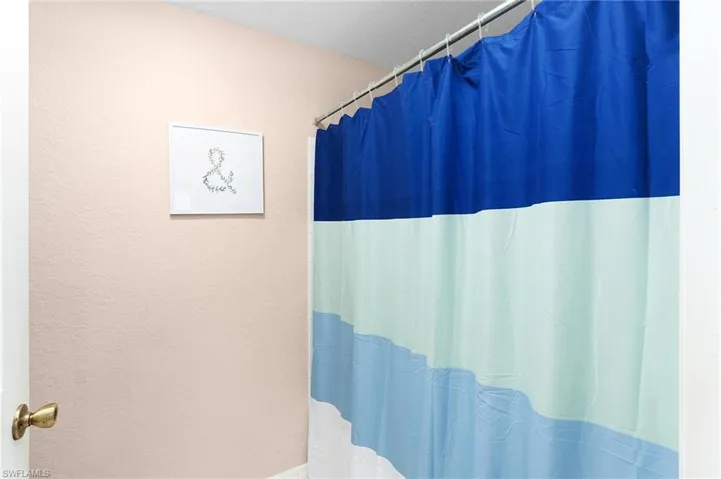 Bathroom featuring a shower with shower curtain