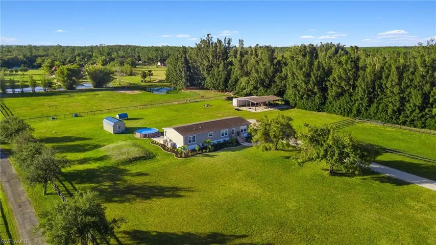 Birds eye view of property featuring a rural view and a water view