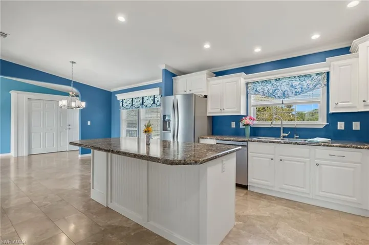 Kitchen featuring white cabinetry, a center island, and stainless steel appliances