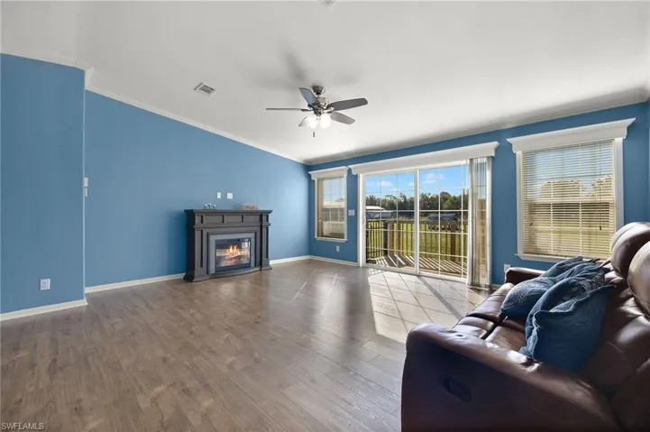Living room featuring crown molding, ceiling fan, and hardwood / wood-style flooring
