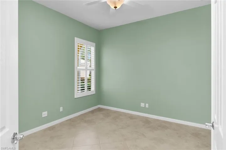 Spare room with baseboards and a ceiling fan