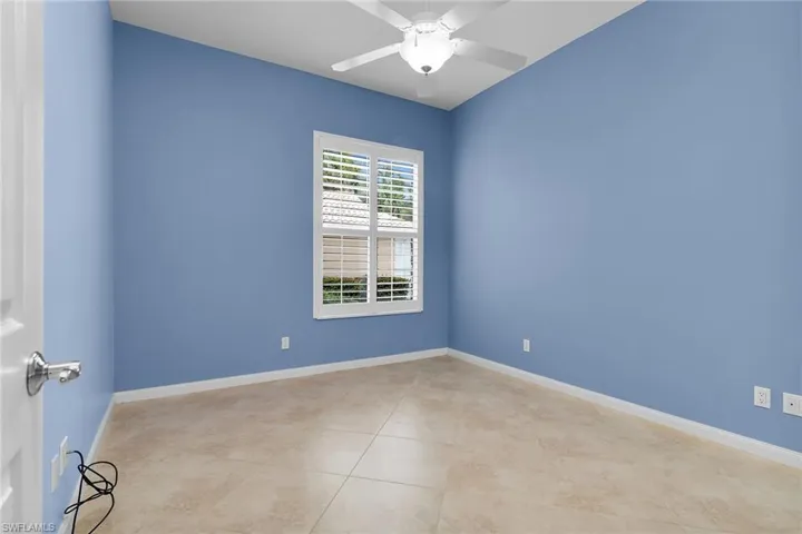 Unfurnished room featuring ceiling fan and light tile patterned floors
