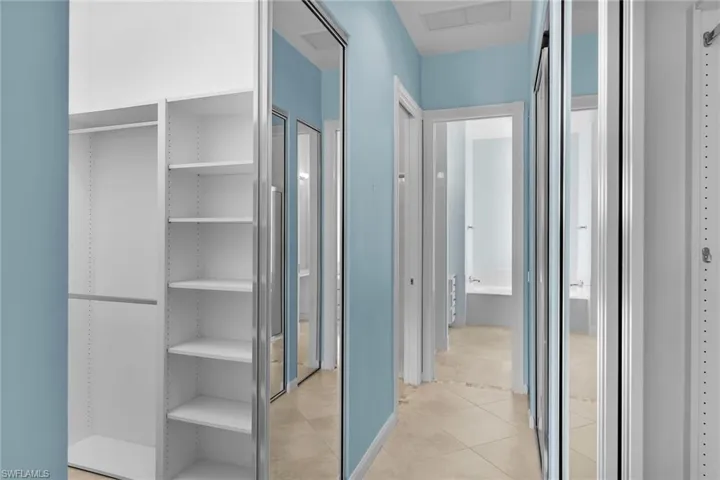 Hallway featuring light tile patterned flooring