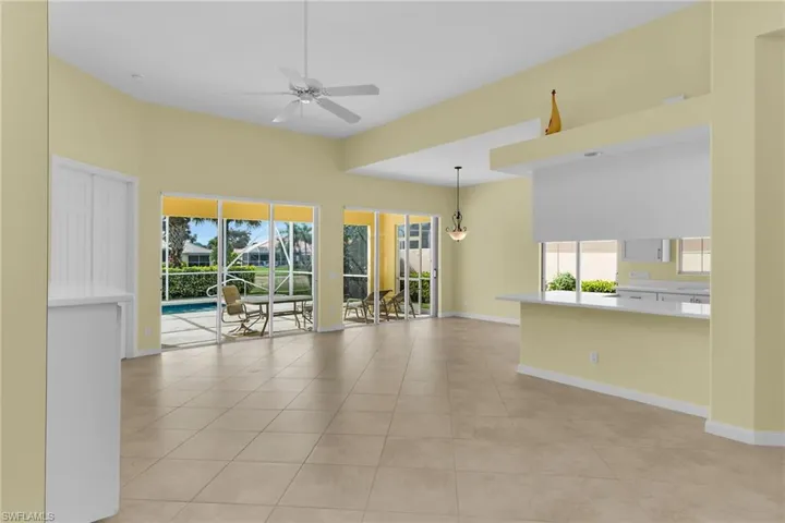 Spare room featuring a sunroom, ceiling fan, and light tile patterned floors