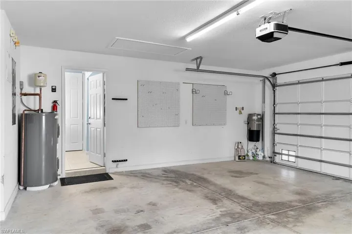 Garage with water heater and a garage door opener