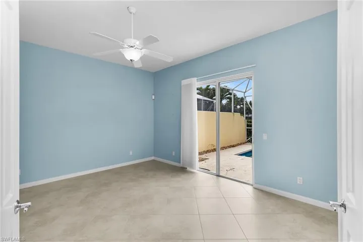 Unfurnished room with a sunroom, light tile patterned floors, and a ceiling fan