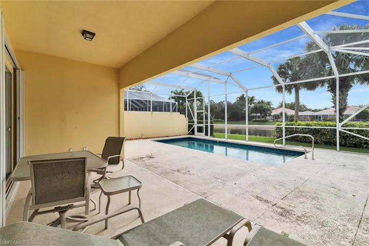 Outdoor pool featuring a patio, a lanai, and a sunroom