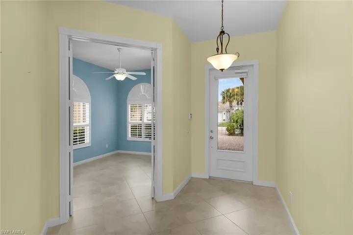 Entryway featuring ceiling fan and light tile patterned floors