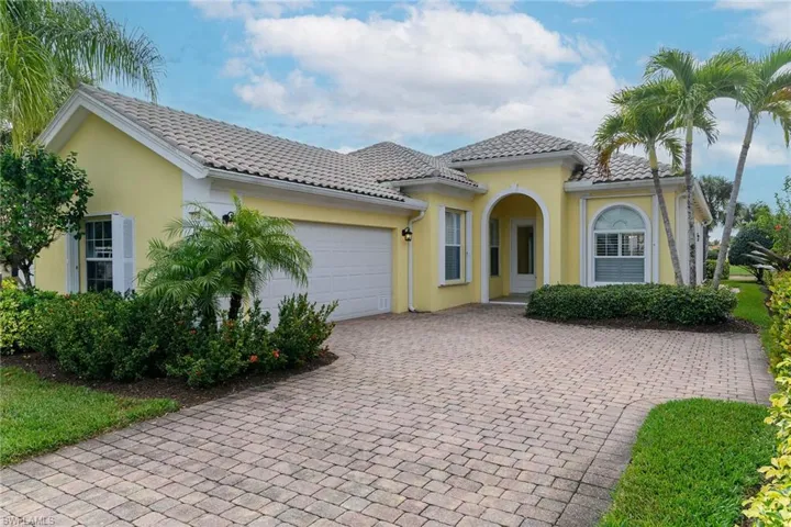 Mediterranean / spanish home with stucco siding, decorative driveway, a tile roof, and a garage