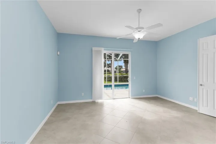 Empty room featuring ceiling fan and light tile patterned flooring