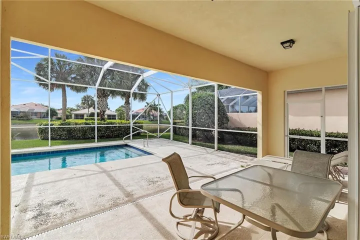 Outdoor pool with a patio, a sunroom, a lanai, and a residential view