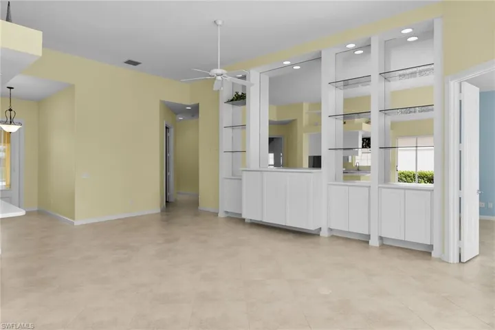 Unfurnished living room featuring healthy amount of natural light and a ceiling fan