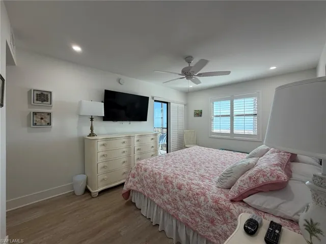 Bedroom with wood finished floors, a ceiling fan, and recessed lighting