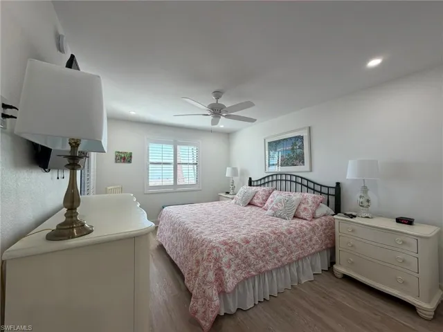 Bedroom with wood finished floors, recessed lighting, and ceiling fan
