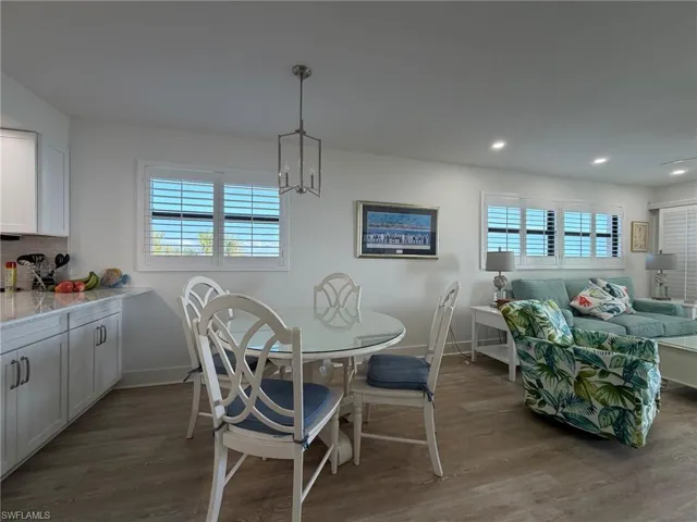 Dining room with dark wood-style floors, plenty of natural light, and recessed lighting