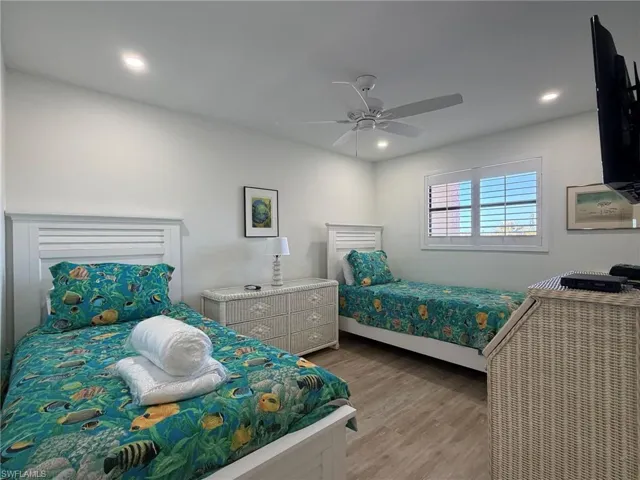 Bedroom featuring light wood-type flooring, a ceiling fan, and recessed lighting