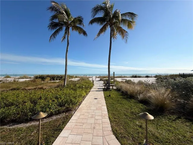 View of property's community with view of water and beach