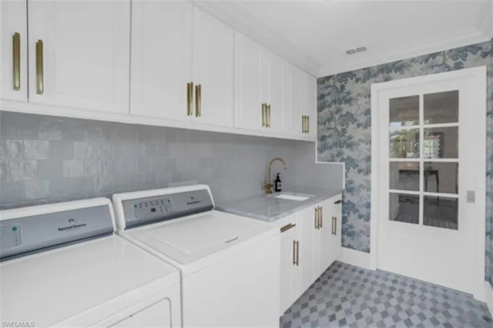 Laundry room with glass door to kitchen.