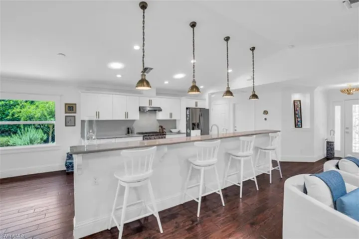Massive island with breakfast bar that can seat four plus chairs.