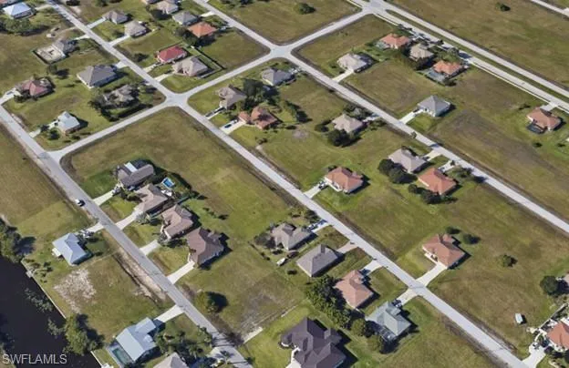 Aerial view of property's location featuring nearby suburban area