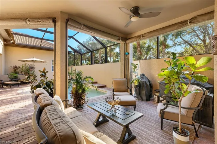 Sunroom / solarium featuring ceiling fan and vaulted ceiling
