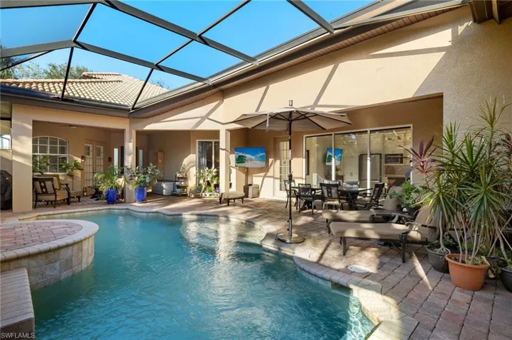 View of swimming pool featuring a lanai and a patio area