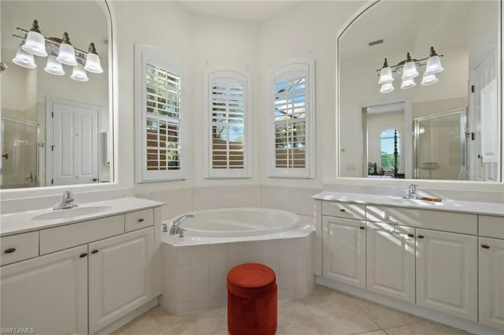 Bathroom featuring tile patterned flooring, vanity, and independent shower and bath
