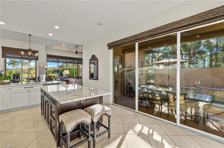 Tiled dining area with a notable chandelier and sink