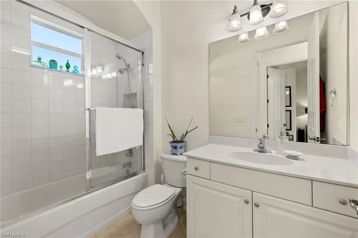 Full bathroom with toilet, combined bath / shower with glass door, and vanity
