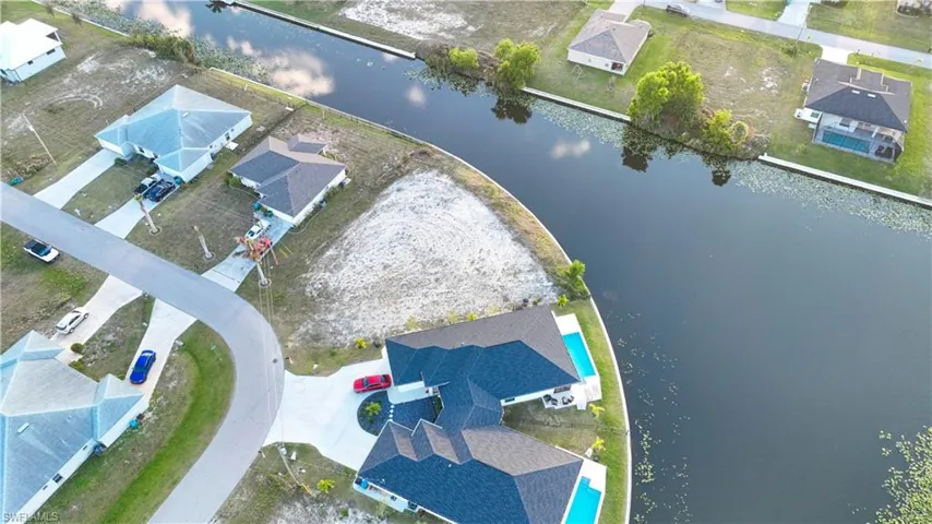 Aerial perspective of suburban area with a nearby body of water
