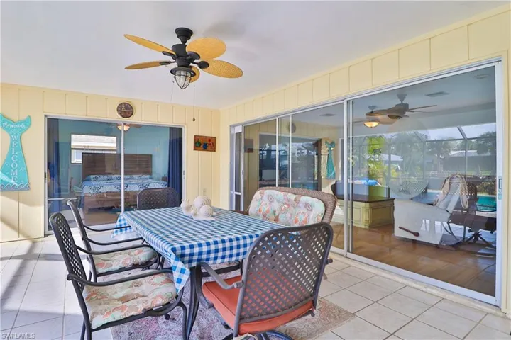 View of patio / terrace featuring ceiling fan and glass enclosure