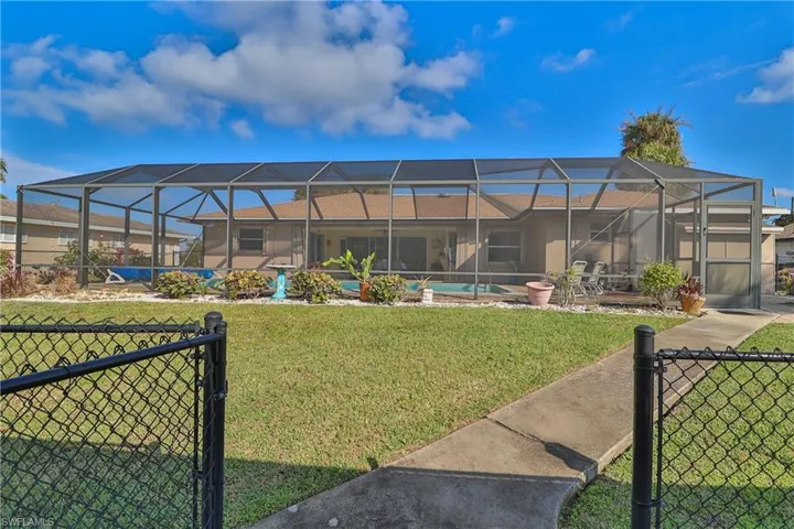 View of yard with a patio area and glass enclosure