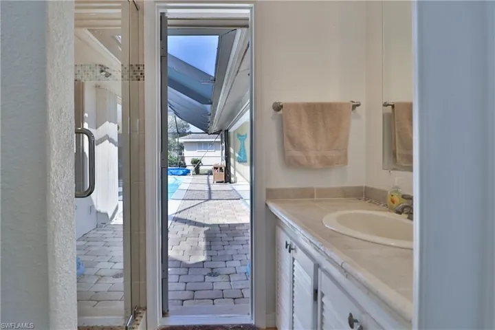 Bathroom featuring vanity and an enclosed shower